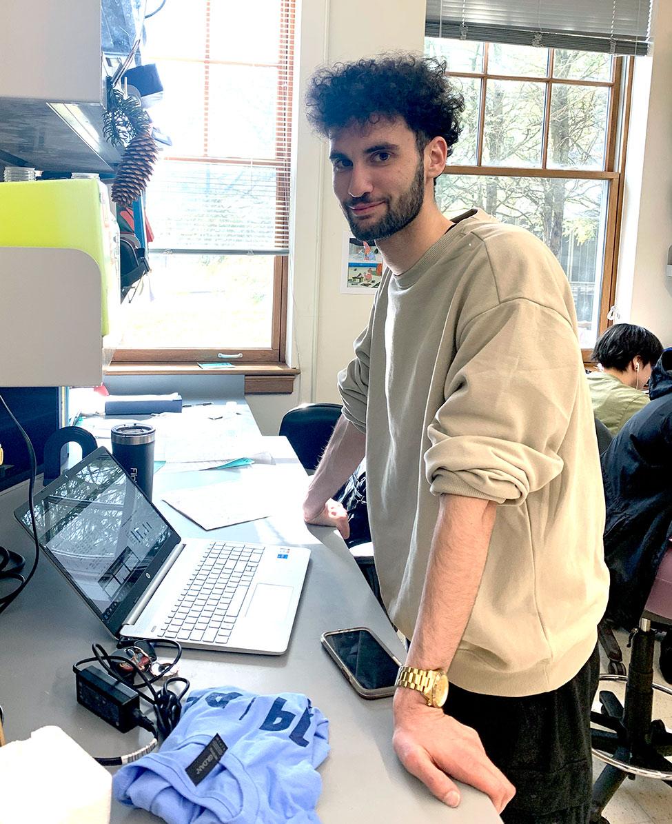 's Biology student Michael Ferretti doing research on a laptop