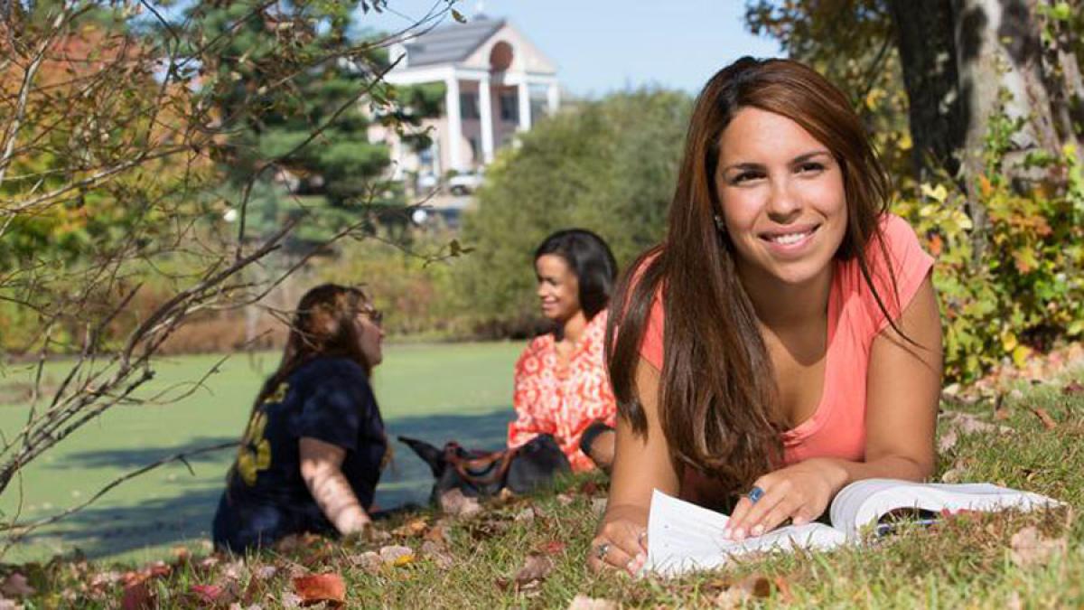 three  students sitting on the lawn of the Pleasantville Campus