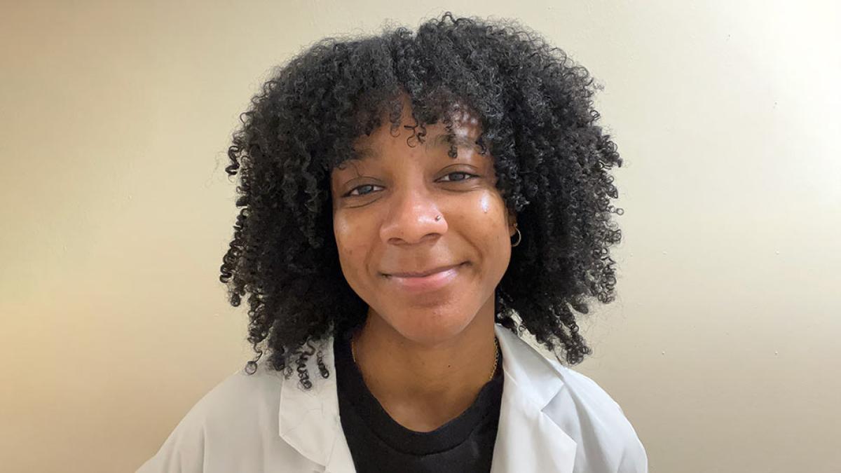  Student Kaylin Smith wears a white coat and smiles