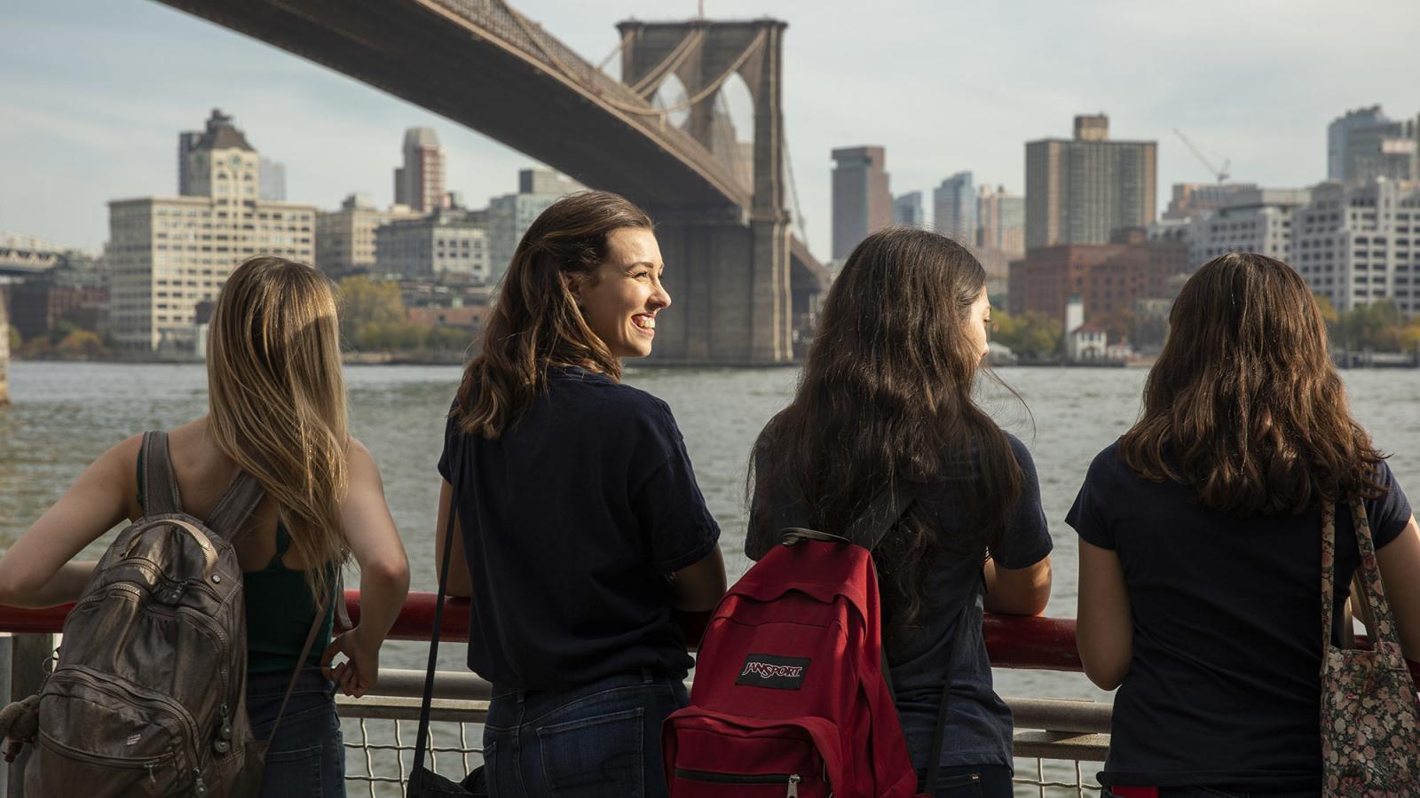  students standing underneath the Brooklyn Bridge