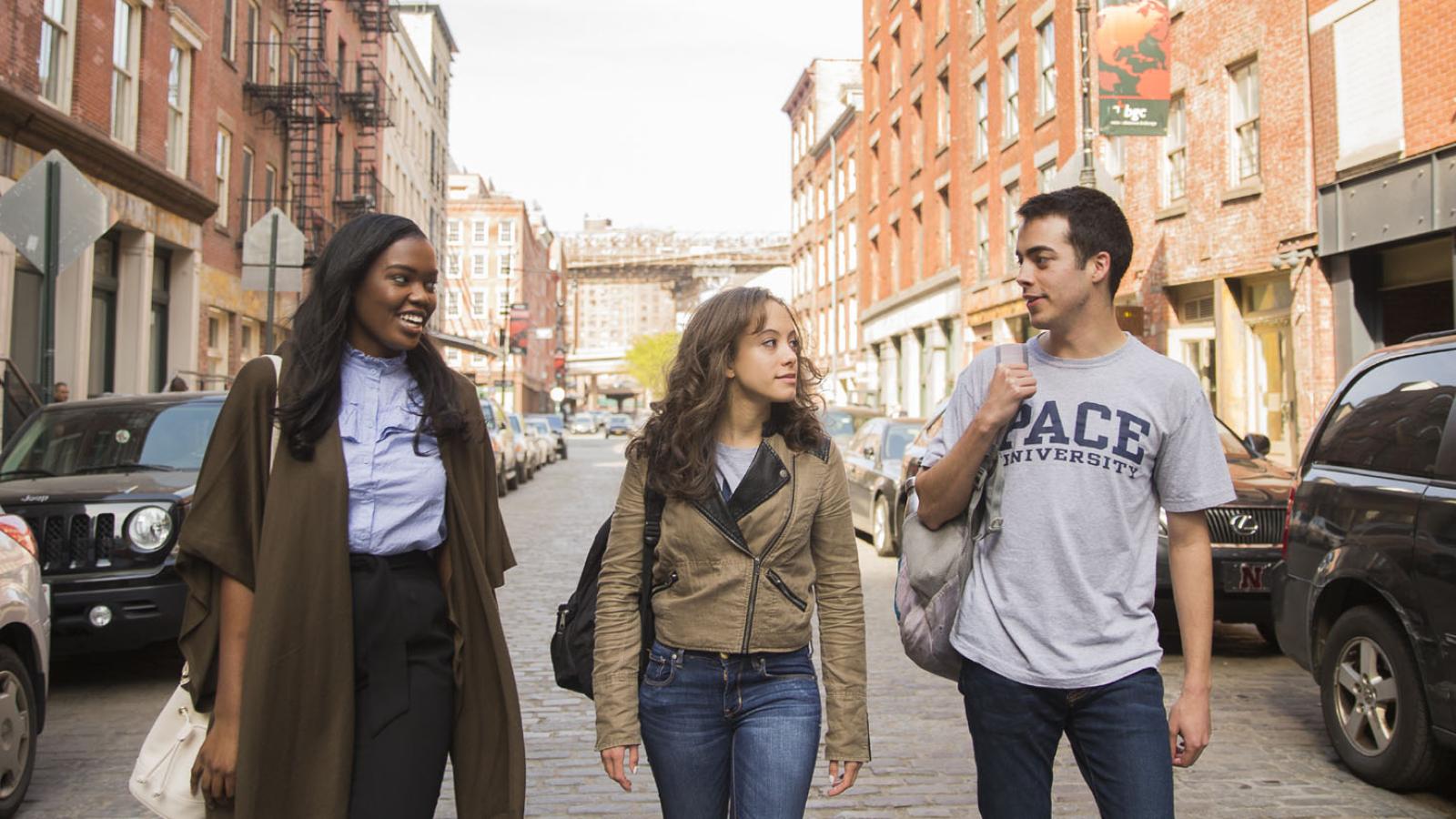 three  students walking in the Seaport district of Lower Manhattan