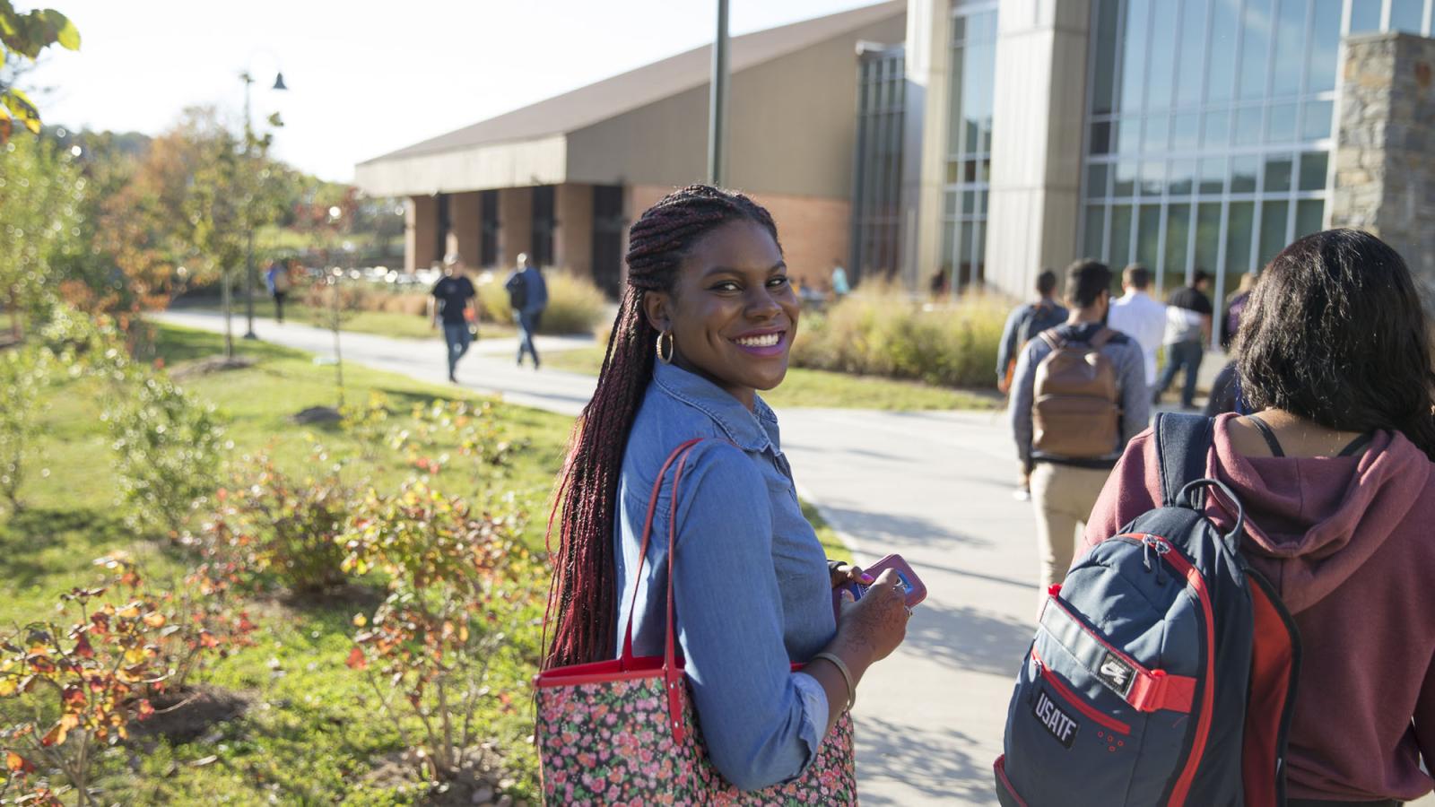 female student walking towards buildings on 's Pleasantville Campus